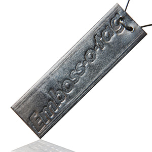Emboss-O-Tag Double Sided Metal Tags with an impression of the text "Emboss-O-Tag" on the front side of the tag.